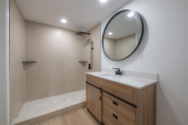6108 Oak Ridge Ave, New Port Richey, FL 34653 - bathroom featuring vanity, tiled shower, and wood finished floors