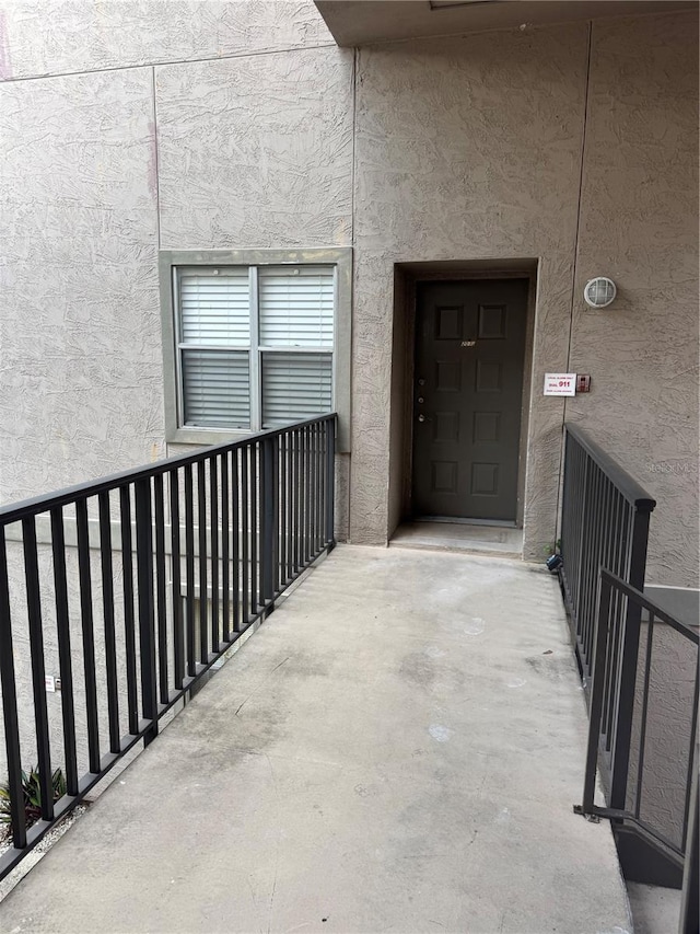 4207 Winding Moss Trl Unit 201, Tampa, FL 33613 - property entrance with stucco siding and a balcony