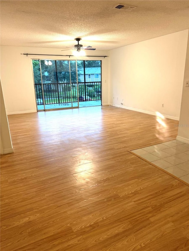 4207 Winding Moss Trl Unit 201, Tampa, FL 33613 - empty room featuring a ceiling fan, a textured ceiling, and wood finished floors