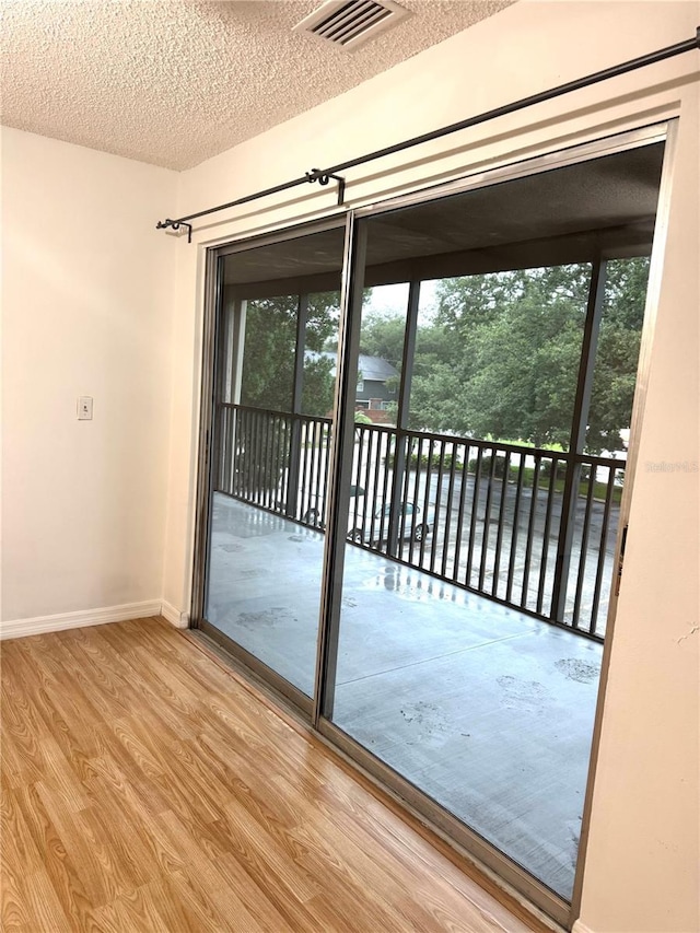 4207 Winding Moss Trl Unit 201, Tampa, FL 33613 - unfurnished room with wood finished floors, a textured ceiling, and a water view