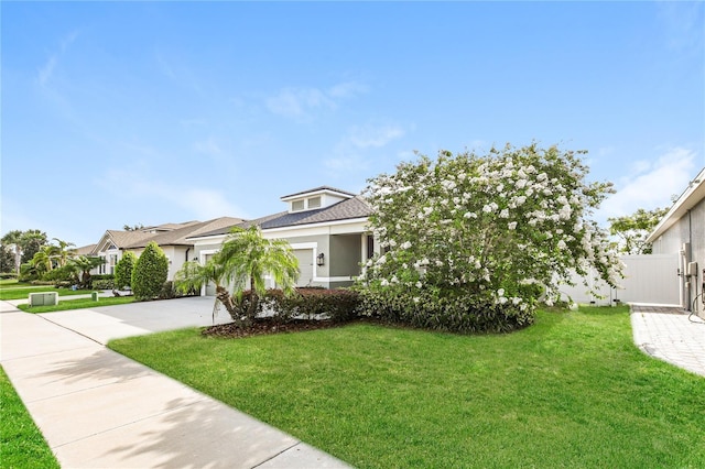 13408 Nimble Minke Unit 155E, Riverview, FL 33579 - view of front of house with concrete driveway, a garage, and stucco siding