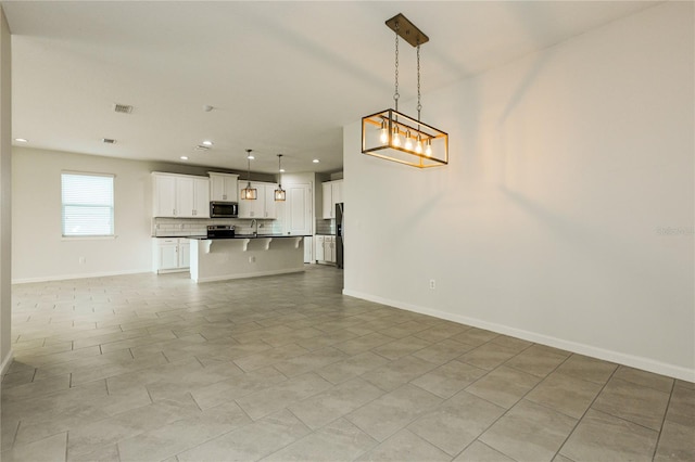 13408 Nimble Minke Unit 155E, Riverview, FL 33579 - unfurnished living room featuring recessed lighting and baseboards