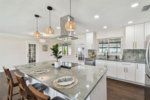 5934 51st Ave N, Kenneth City, FL 33709 - kitchen with island range hood, stainless steel appliances, dark wood-style flooring, light stone counters, and plenty of natural light