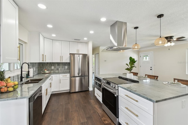 5934 51st Ave N, Kenneth City, FL 33709 - kitchen with appliances with stainless steel finishes, island exhaust hood, light stone counters, decorative backsplash, and recessed lighting