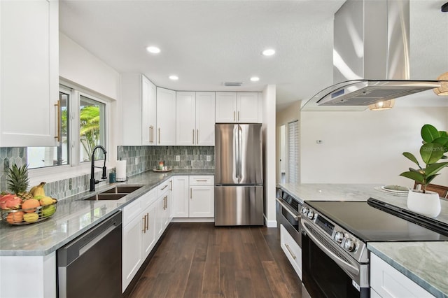 5934 51st Ave N, Kenneth City, FL 33709 - kitchen featuring island exhaust hood, stainless steel appliances, light stone countertops, recessed lighting, and decorative backsplash