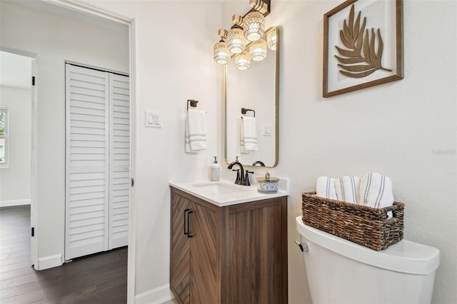5934 51st Ave N, Kenneth City, FL 33709 - bathroom with vanity, a chandelier, wood finished floors, and a closet