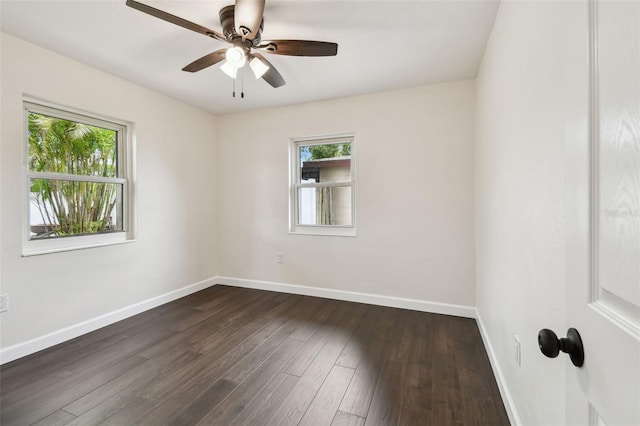 5934 51st Ave N, Kenneth City, FL 33709 - spare room featuring plenty of natural light, dark wood finished floors, and ceiling fan