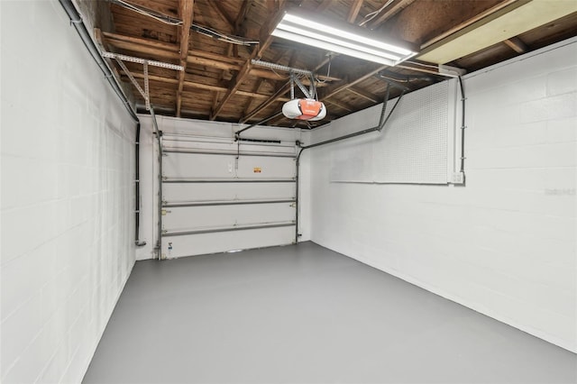 5934 51st Ave N, Kenneth City, FL 33709 - garage featuring a garage door opener and concrete block wall