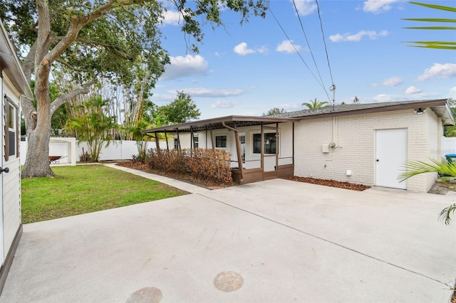 5934 51st Ave N, Kenneth City, FL 33709 - view of front of home with covered porch, brick siding, and a patio area