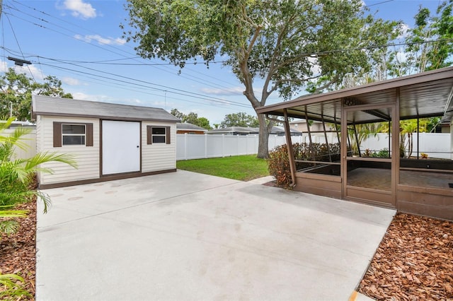 5934 51st Ave N, Kenneth City, FL 33709 - view of patio featuring a sunroom and an outdoor structure