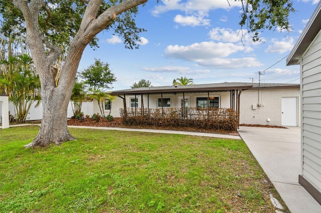5934 51st Ave N, Kenneth City, FL 33709 - ranch-style home with a front lawn and a porch
