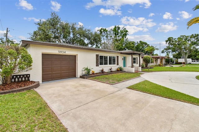 5934 51st Ave N, Kenneth City, FL 33709 - ranch-style house featuring driveway, an attached garage, brick siding, and a front yard