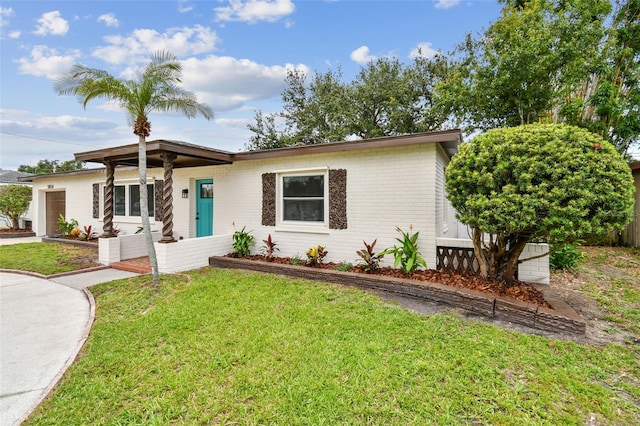 5934 51st Ave N, Kenneth City, FL 33709 - mid-century home featuring a front yard, brick siding, and an attached garage