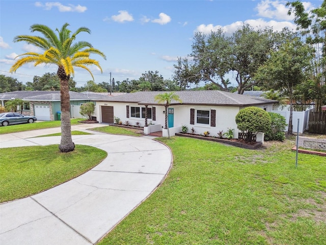 5934 51st Ave N, Kenneth City, FL 33709 - ranch-style home featuring curved driveway, an attached garage, and stucco siding