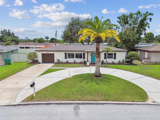 5934 51st Ave N, Kenneth City, FL 33709 - single story home with curved driveway, an attached garage, and stucco siding