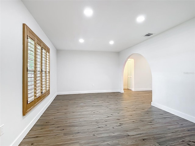 20352 Astoria Ave, Port Charlotte, FL 33952 - empty room with arched walkways, wood finished floors, and recessed lighting