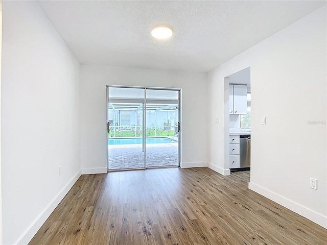 20352 Astoria Ave, Port Charlotte, FL 33952 - empty room with wood finished floors and baseboards