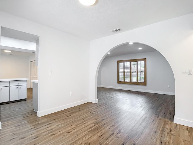 20352 Astoria Ave, Port Charlotte, FL 33952 - empty room with wood finished floors and arched walkways