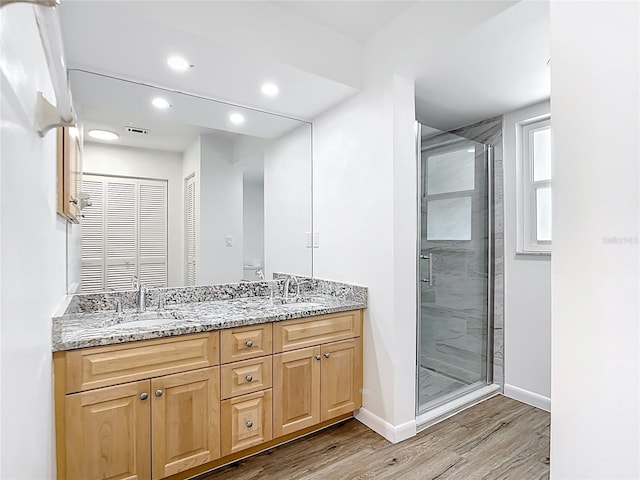20352 Astoria Ave, Port Charlotte, FL 33952 - full bathroom with double vanity, wood finished floors, a stall shower, and recessed lighting