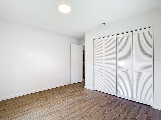 20352 Astoria Ave, Port Charlotte, FL 33952 - unfurnished bedroom featuring wood finished floors and a closet