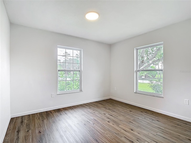 20352 Astoria Ave, Port Charlotte, FL 33952 - empty room featuring healthy amount of natural light and wood finished floors