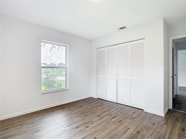 20352 Astoria Ave, Port Charlotte, FL 33952 - unfurnished bedroom featuring wood finished floors and a closet
