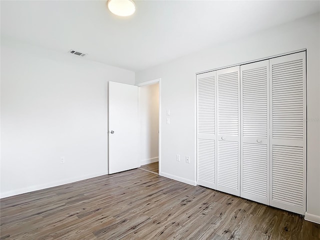 20352 Astoria Ave, Port Charlotte, FL 33952 - unfurnished bedroom with wood finished floors and a closet