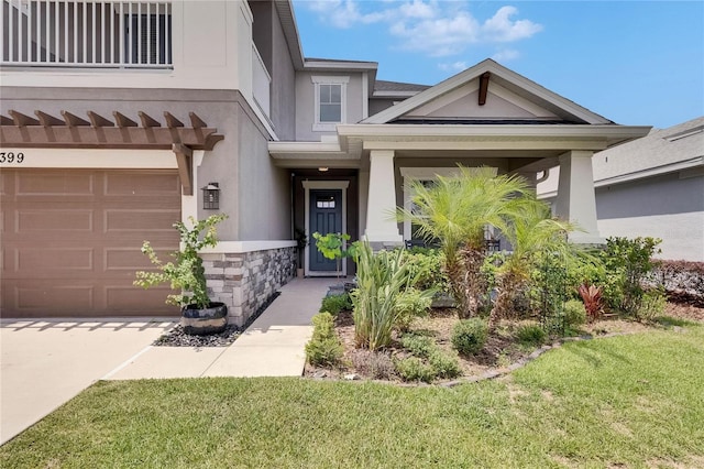 10399 Boyette Brook St, Riverview, FL 33569 - view of front facade featuring stone siding, an attached garage, stucco siding, and a front lawn