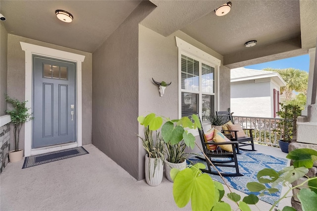 10399 Boyette Brook St, Riverview, FL 33569 - doorway to property featuring covered porch and stucco siding