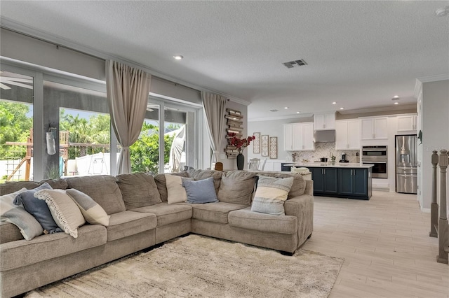 10399 Boyette Brook St, Riverview, FL 33569 - living room with ornamental molding, light wood finished floors, a textured ceiling, and recessed lighting