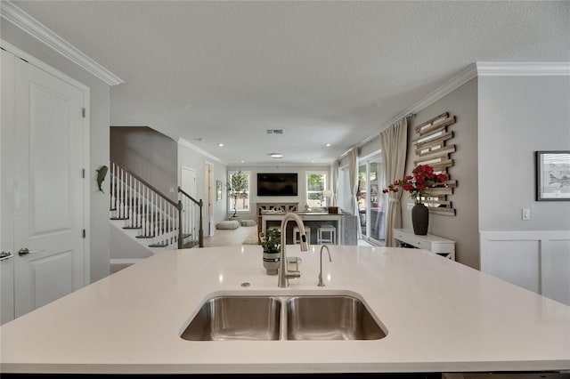 10399 Boyette Brook St, Riverview, FL 33569 - kitchen with light countertops, ornamental molding, open floor plan, and a kitchen island with sink