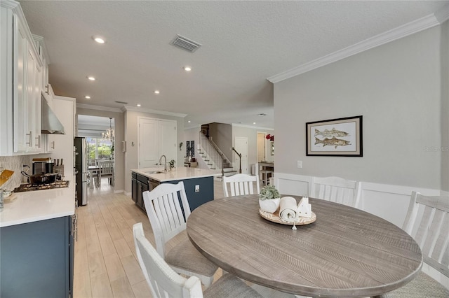 10399 Boyette Brook St, Riverview, FL 33569 - dining area featuring stairs, ornamental molding, recessed lighting, and light wood-style flooring