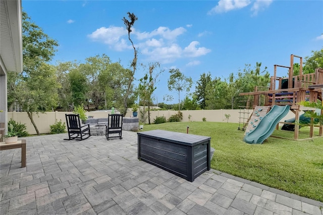 10399 Boyette Brook St, Riverview, FL 33569 - fenced backyard featuring an outdoor fire pit, a patio, and a playground