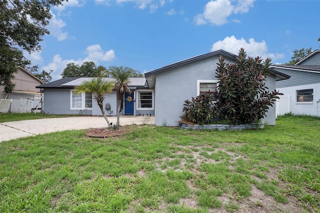 15906 Country Farm Pl, Tampa, FL 33624 - view of front of home with stucco siding, a front yard, and driveway