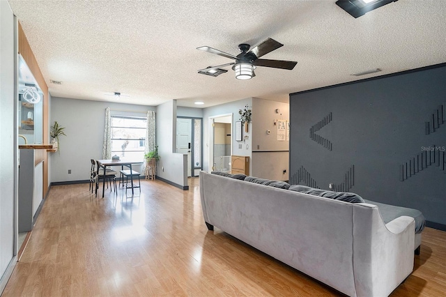 15906 Country Farm Pl, Tampa, FL 33624 - living area with ceiling fan, light wood finished floors, and a textured ceiling