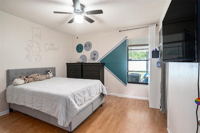 15906 Country Farm Pl, Tampa, FL 33624 - bedroom featuring light wood finished floors, a textured ceiling, and ceiling fan