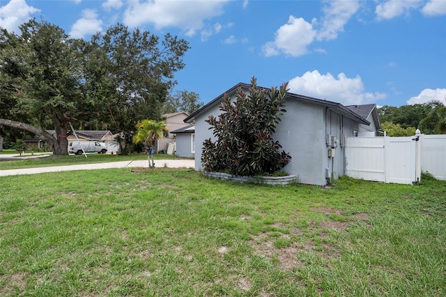 15906 Country Farm Pl, Tampa, FL 33624 - view of home's exterior with stucco siding, a gate, and driveway