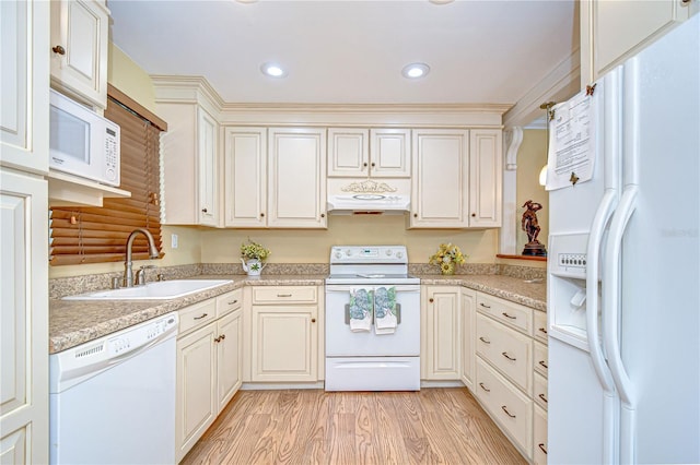 340 Pinellas Bayway S Unit 304, Saint Petersburg, FL 33715 - kitchen with white appliances, under cabinet range hood, light countertops, light wood-style floors, and recessed lighting