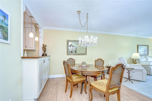 340 Pinellas Bayway S Unit 304, Saint Petersburg, FL 33715 - dining room featuring a chandelier, ornamental molding, and light wood-style floors