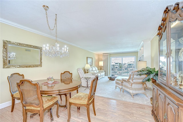 340 Pinellas Bayway S Unit 304, Saint Petersburg, FL 33715 - dining space with a chandelier, ornamental molding, and light wood-type flooring
