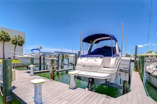 340 Pinellas Bayway S Unit 304, Saint Petersburg, FL 33715 - dock featuring boat lift and a water view
