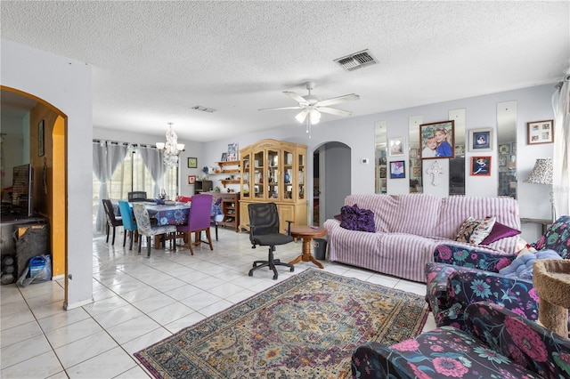 7018 Arbor View Ln, New Port Richey, FL 34653 - living area with arched walkways, a chandelier, ceiling fan, a textured ceiling, and light tile patterned flooring
