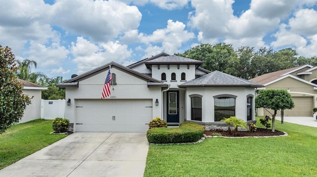 12251 Duckett Ct, Spring Hill, FL 34610 - view of front of home featuring concrete driveway, stucco siding, an attached garage, and roof with shingles