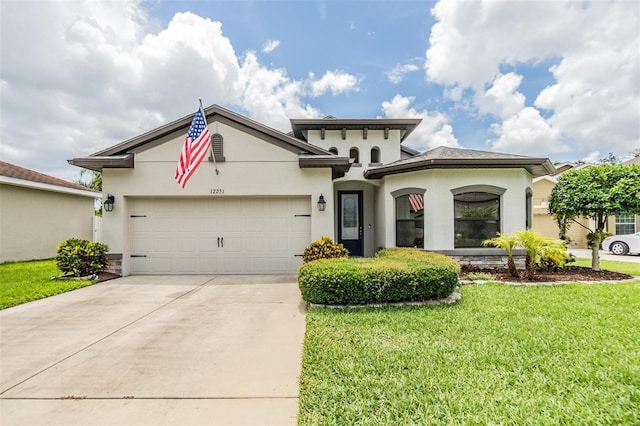 12251 Duckett Ct, Spring Hill, FL 34610 - view of front of property featuring concrete driveway, stucco siding, a garage, and a front lawn