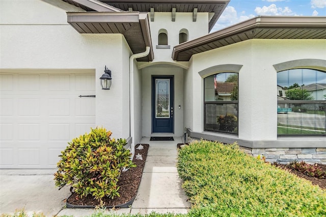 12251 Duckett Ct, Spring Hill, FL 34610 - property entrance with stucco siding and a garage
