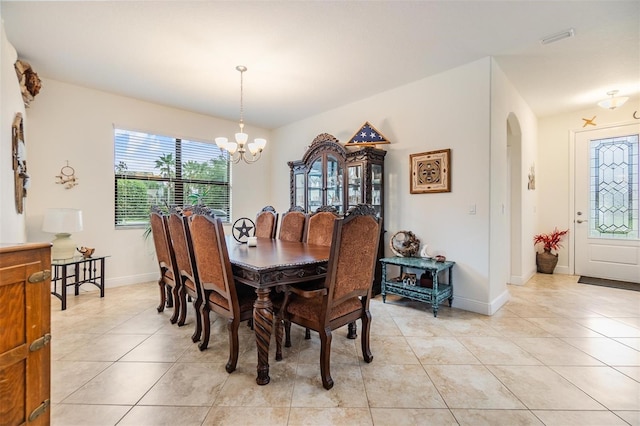 12251 Duckett Ct, Spring Hill, FL 34610 - dining space with a chandelier, light tile patterned floors, and arched walkways