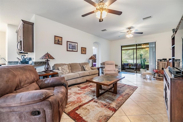 12251 Duckett Ct, Spring Hill, FL 34610 - living room with ceiling fan, arched walkways, and light tile patterned flooring