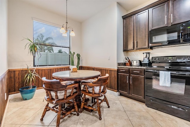 12251 Duckett Ct, Spring Hill, FL 34610 - kitchen with black appliances, wainscoting, wood walls, dark brown cabinetry, and a chandelier