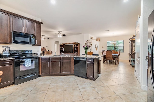 12251 Duckett Ct, Spring Hill, FL 34610 - kitchen with black appliances, dark brown cabinetry, a peninsula, and light tile patterned floors