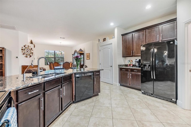 12251 Duckett Ct, Spring Hill, FL 34610 - kitchen with black appliances, stone countertops, dark brown cabinets, light tile patterned floors, and a chandelier